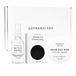 Skincare gift set with toner, soap, and facial mask in white packaging