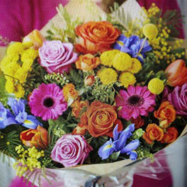 Mixed bouquet of roses, daisies, and yellow pom flowers