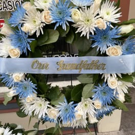 Blue and white floral wreath with a ribbon reading "Our Grandfather"