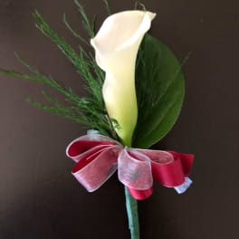 White calla lily boutonniere with red ribbon bow