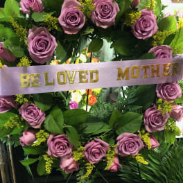 Lavender rose wreath with a "Be Loved Mother" ribbon