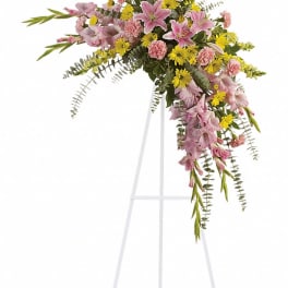 Pink and yellow floral spray on a white easel