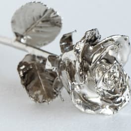 Silver rose-shaped decorative picks on stems
