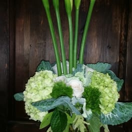 Tall bouquet of white calla lilies and pale green hydrangeas