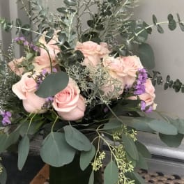 Bouquet of pale pink roses with eucalyptus in a vase