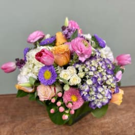 Mixed bouquet with roses, tulips, hydrangea, and purple daisies