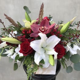 Red roses and white lilies in a low black container