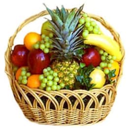 Fruit basket with pineapple, bananas, apples, grapes, and oranges