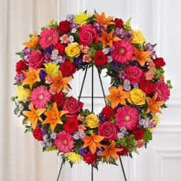 Colorful floral wreath on a black stand