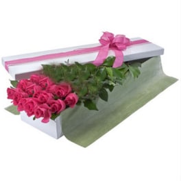 Pink roses in a white gift box with a pink ribbon