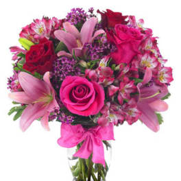 Pink and red bouquet of roses and lilies in a clear glass vase