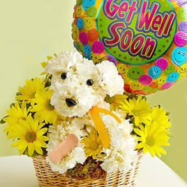 Basket of white and yellow flowers with a "Get Well Soon" balloon