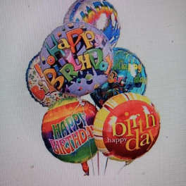 Cluster of colorful birthday balloons with printed messages