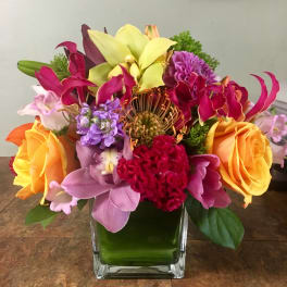 Colorful mixed bouquet in a square glass vase