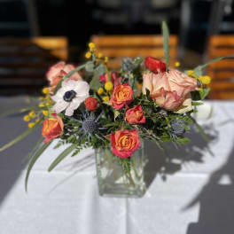 Mixed bouquet of roses and anemones in a clear glass vase