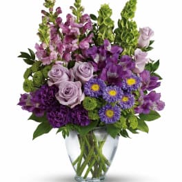 Purple and lavender bouquet in a clear glass vase