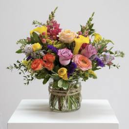 Mixed bouquet of colorful flowers in a glass vase