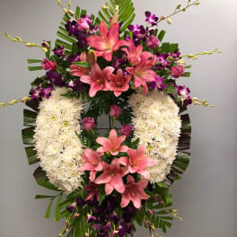 Standing floral spray with pink lilies, purple orchids, and white chrysanthemums