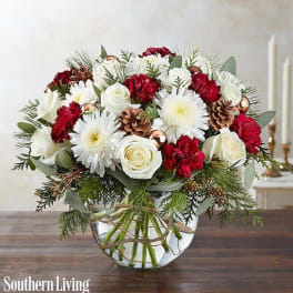 Red and white floral arrangement in a clear glass vase