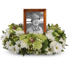 Green and white sympathy floral frame with a photo in the center