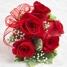 Bouquet of red roses with baby’s breath and a red ribbon
