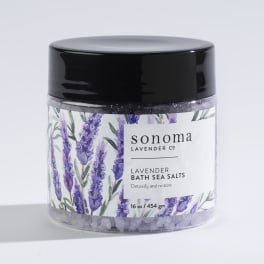 Jar of lavender bath sea salts with illustrated lavender sprigs on the label