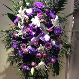 Large purple and white floral standing spray with lilies and roses