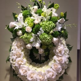 Standing floral wreath with white roses and green blooms