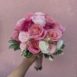 Pink rose bouquet with white blooms and variegated leaves