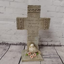 Decorative memorial cross with a bird and flowers