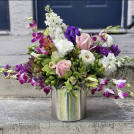 Pink and white floral arrangement in a silver vase
