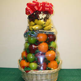 Basket of assorted fruit wrapped in clear cellophane with a red bow