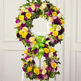 Floral wreath in the shape of a number 8 with a green ribbon bow