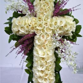White rose cross arrangement with purple accents