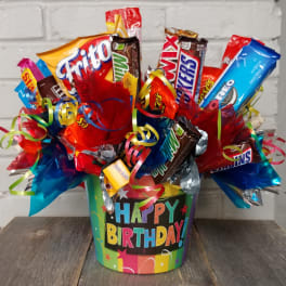 Birthday candy bouquet in a colorful bucket with assorted candy bars and ribbons.