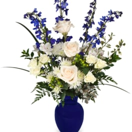 Blue and white floral arrangement in a cobalt vase