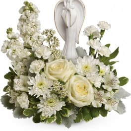 White floral arrangement with an angel figurine centerpiece