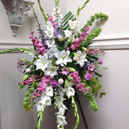 Tall standing floral spray with white lilies and pink-purple flowers