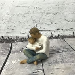 Small figurine of a person holding a child