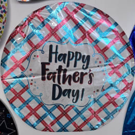 Round foil balloon reading Happy Father's Day