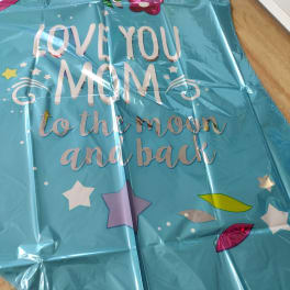 Blue foil balloon with the words "Love you Mom to the moon and back"
