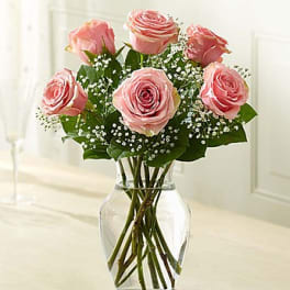 Pink roses arranged in a clear glass vase