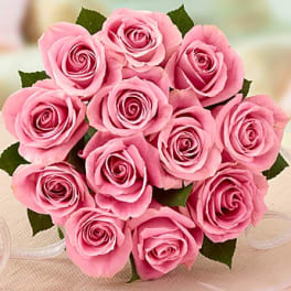 Bouquet of pink roses with a white ribbon wrap