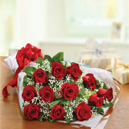 Bouquet of red roses with baby's breath wrapped in white paper