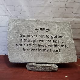Memorial stone plaque with an engraved remembrance message