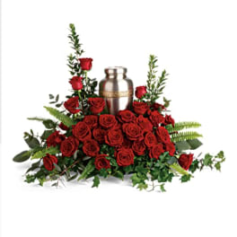Red rose arrangement with a silver urn centerpiece