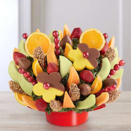 Fruit bouquet with chocolate-dipped strawberries and orange slices in a red container