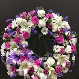Heart-shaped floral wreath with pink, white, and purple flowers