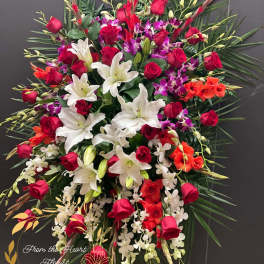 Large standing spray of red roses, white lilies, and purple orchids
