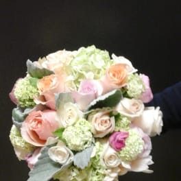 Bouquet of pastel roses and hydrangeas with silvery foliage